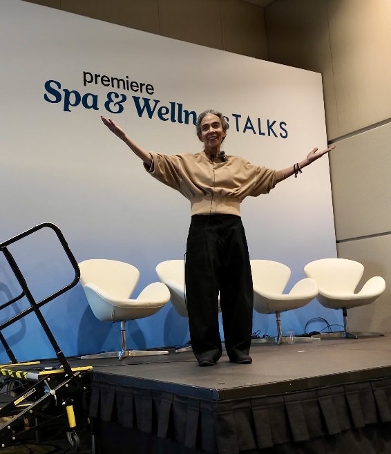 Sylvia Sepielli speaking with open arms at Premiere Spa and Wellness Talks